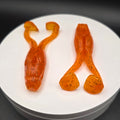 Orange Fishing Lure on white round surface with black background