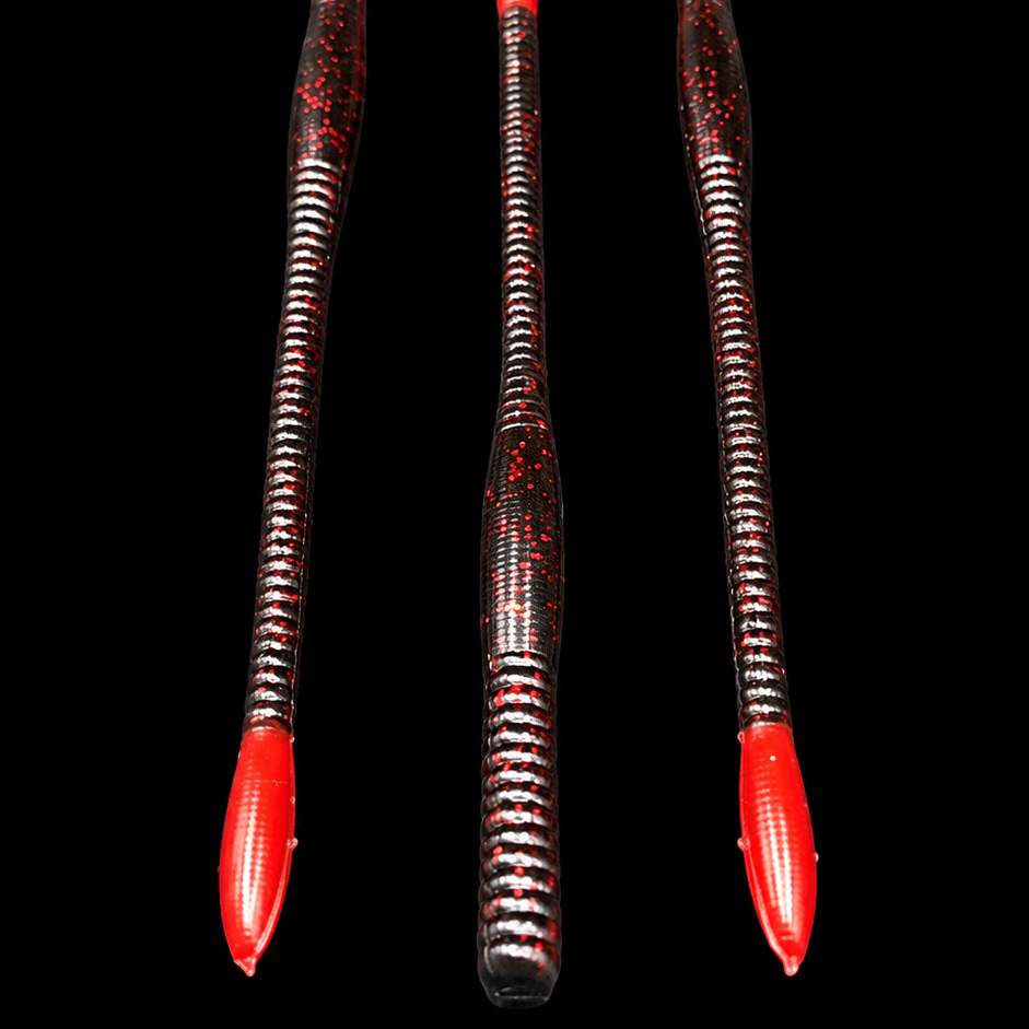 Three red and black fishing lures on a black background