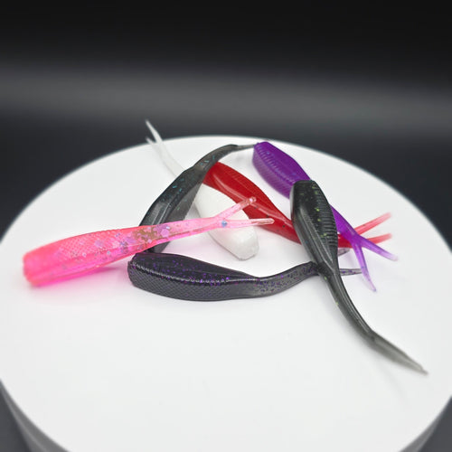 Colorful fishing lures on a white circular base against a dark background