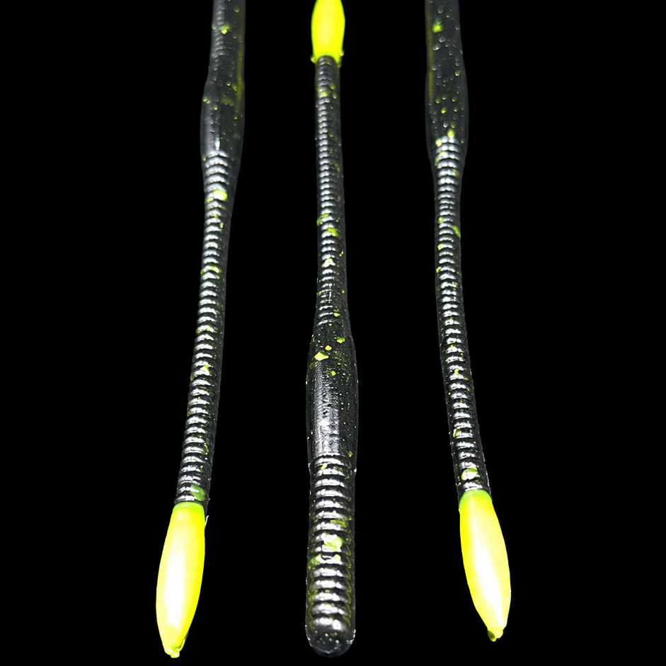 Three fishing lures with yellow tips on a black background