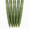 Five green fishing lures with a glittery finish on a white background